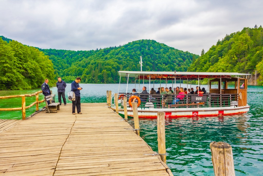 Electric boats take visitors across the largest lake, Kozjak, in Plitvice Lakes National Park in Croatia.