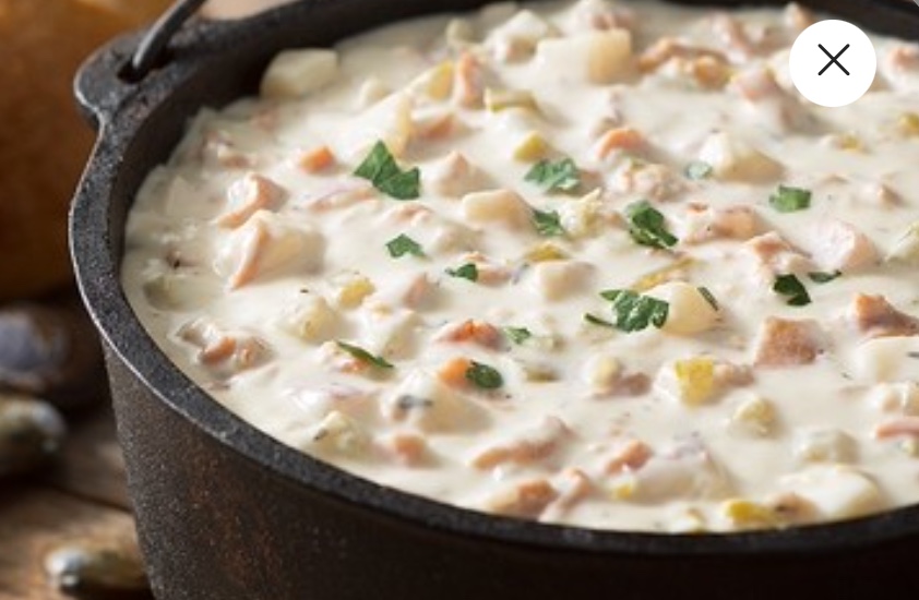 The award-winning New England Clam Chowder at Pike Place Chowder in Seattle has clams, bacon, cream, and spices.